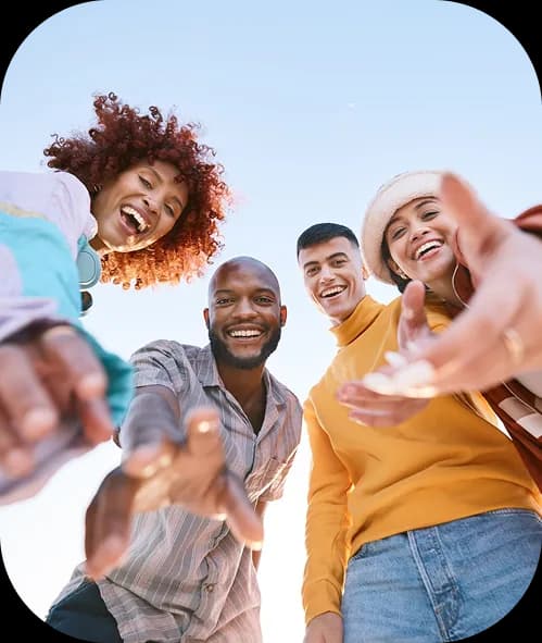 Group of diverse friends reaching toward camera